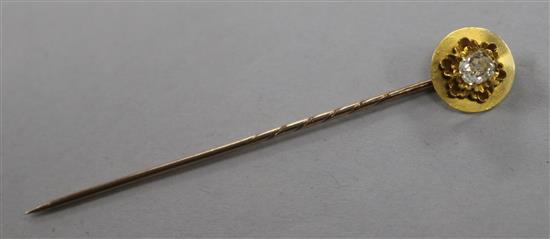 A yellow metal and solitaire diamond set stick pin 73mm.